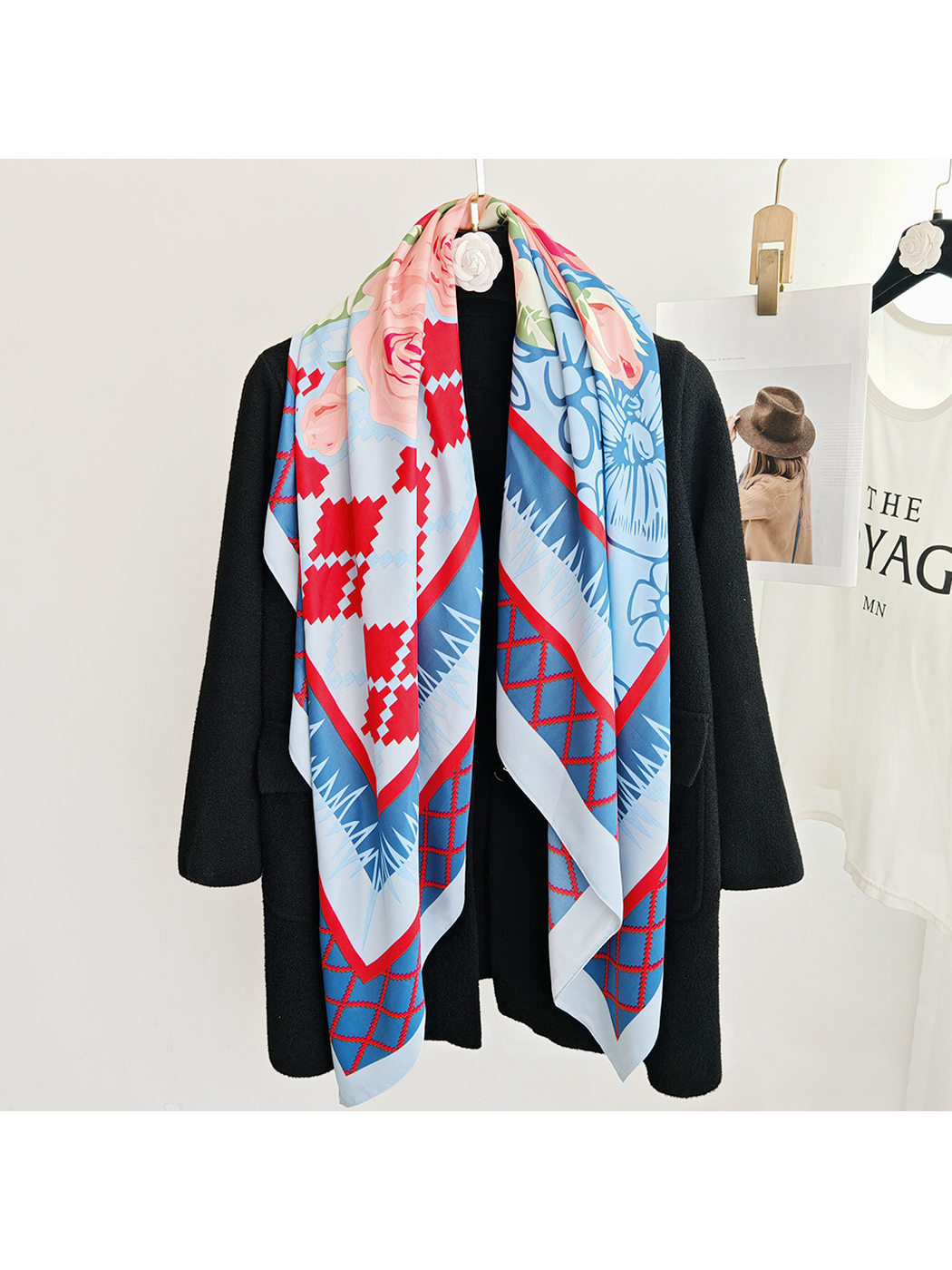 Blue floral square scarf styled lengthwise over a black coat