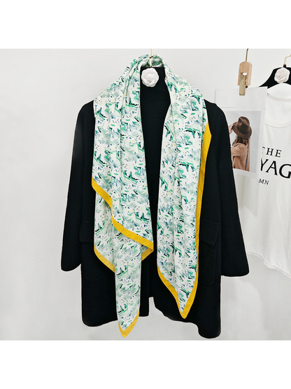 Mint abstract floral square scarf styled in a long drape over a black coat