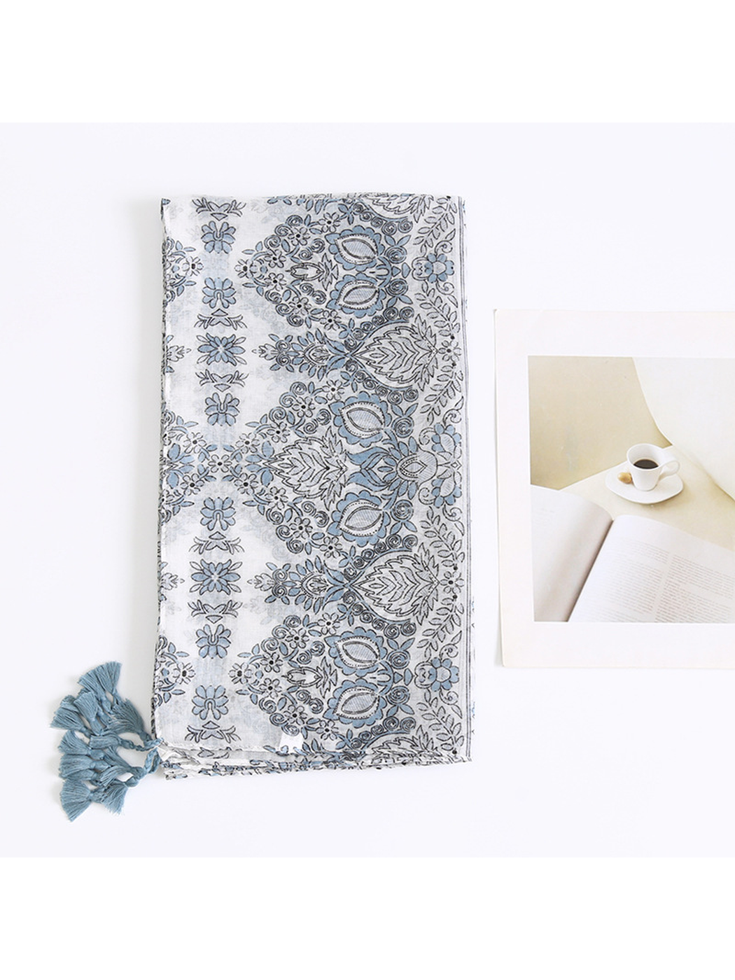 Folded blue-gray scarf showing the paisley border and floral pattern