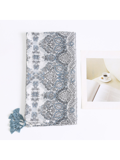 Folded blue-gray scarf showing the paisley border and floral pattern