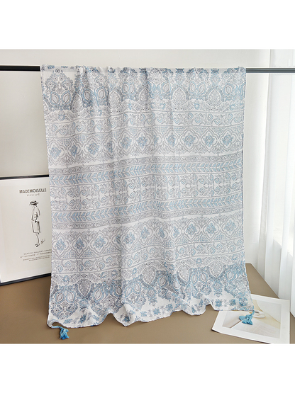 Blue-gray rectangular paisley scarf draped over a display rail