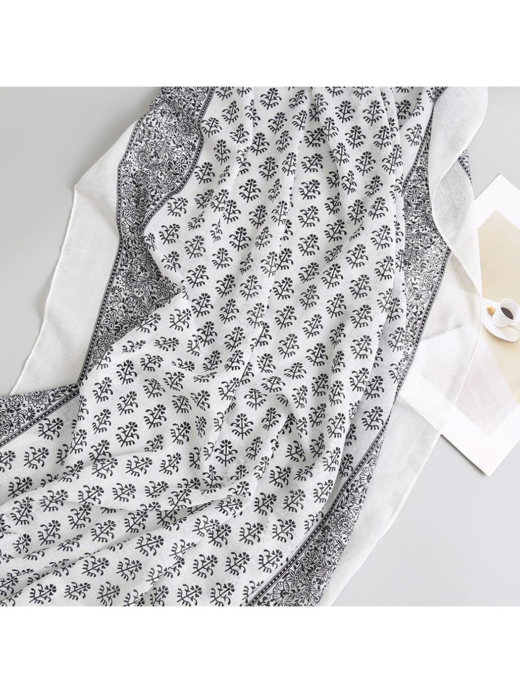 Close-up of the black botanical print and ornate floral border