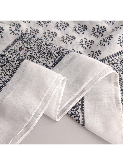 Close-up of the scarf's stitched edge and floral border