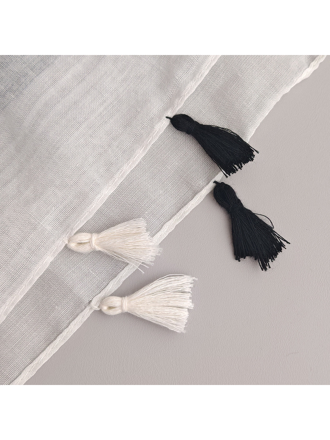 Close-up of the alternating black and white tassel trim
