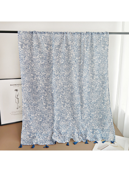 Rectangular white and navy floral scarf draped over a display rail