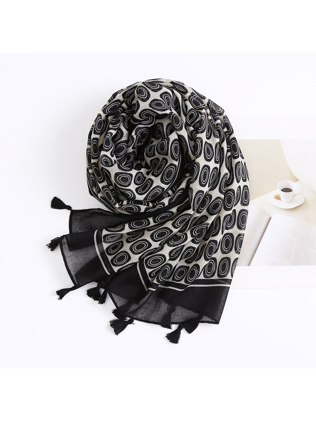 Black scarf with repeating oval pattern and tasseled edges