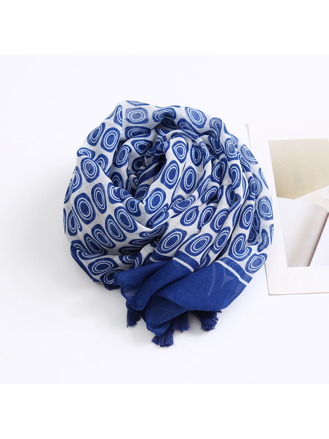 Navy oval-pattern scarf arranged in a compact draped view