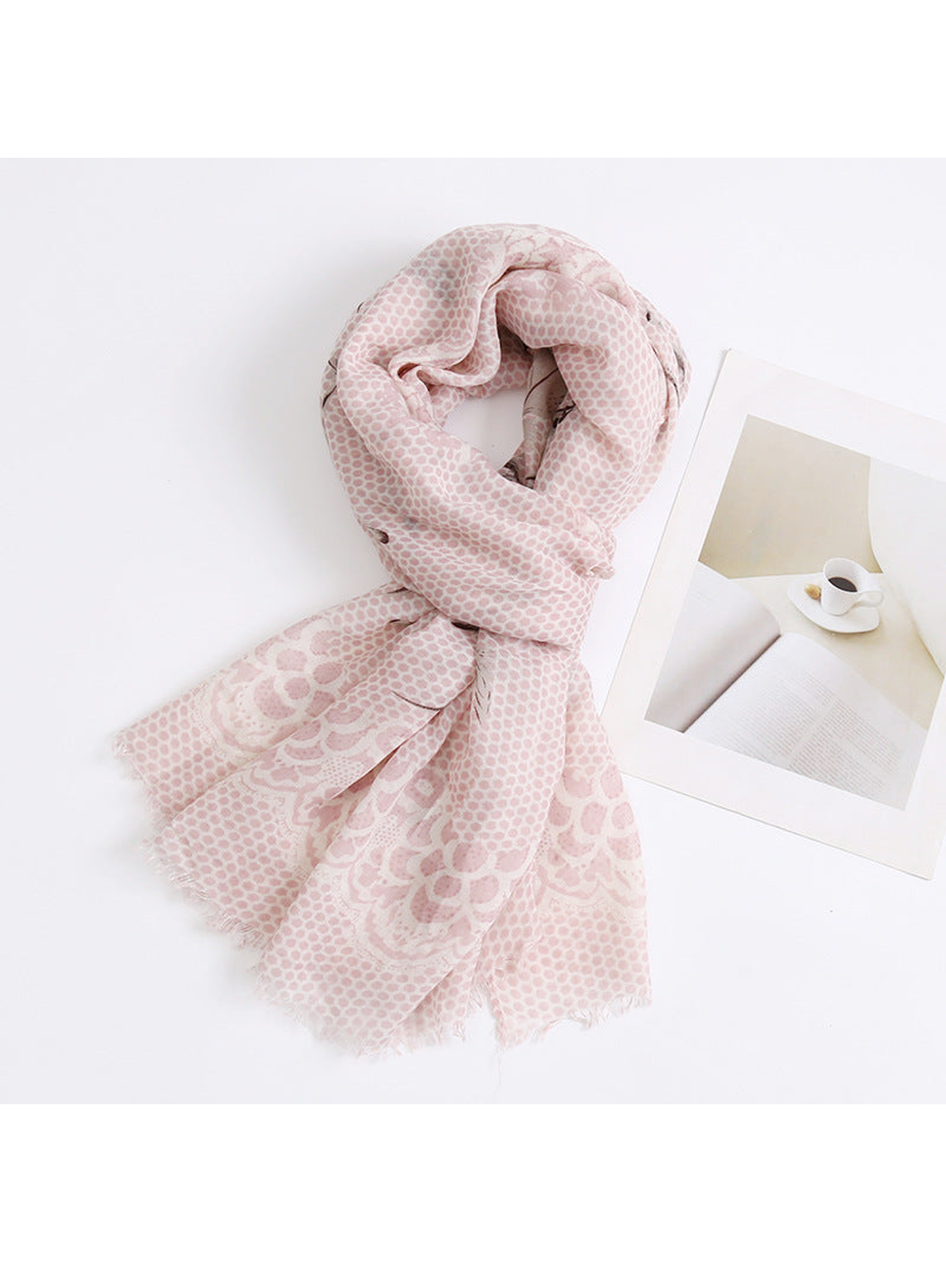 Light pink patterned scarf arranged in a loose loop