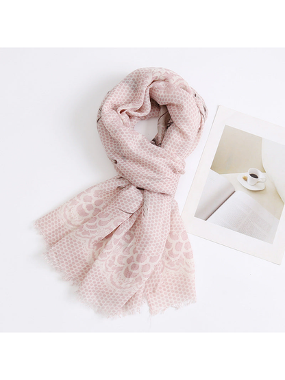 Light pink patterned scarf arranged in a loose loop