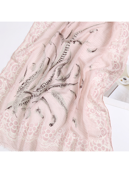 Close-up of the light pink scarf's feather motif and ornate floral border