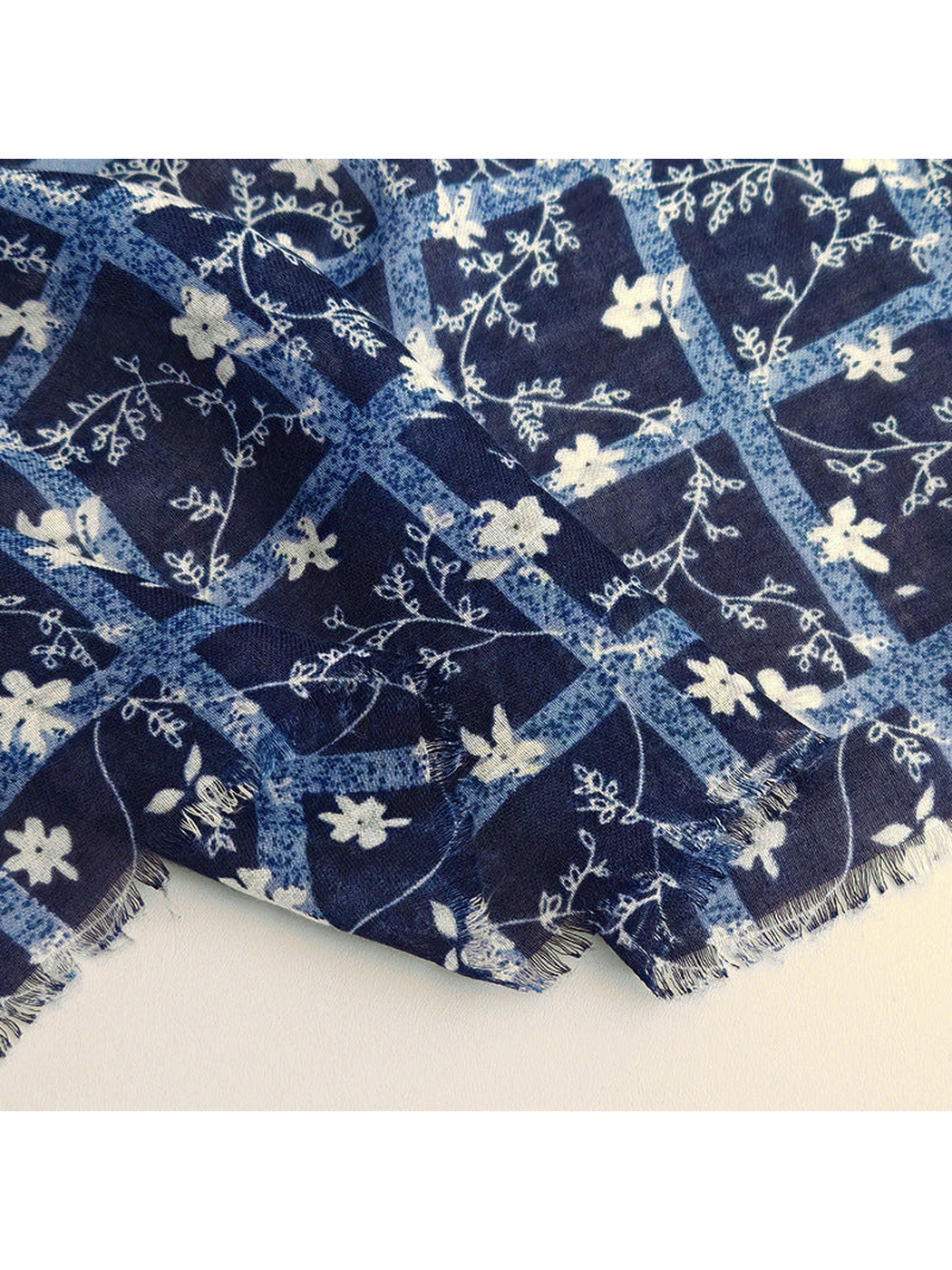 Close-up of the navy floral border and short fringed edge