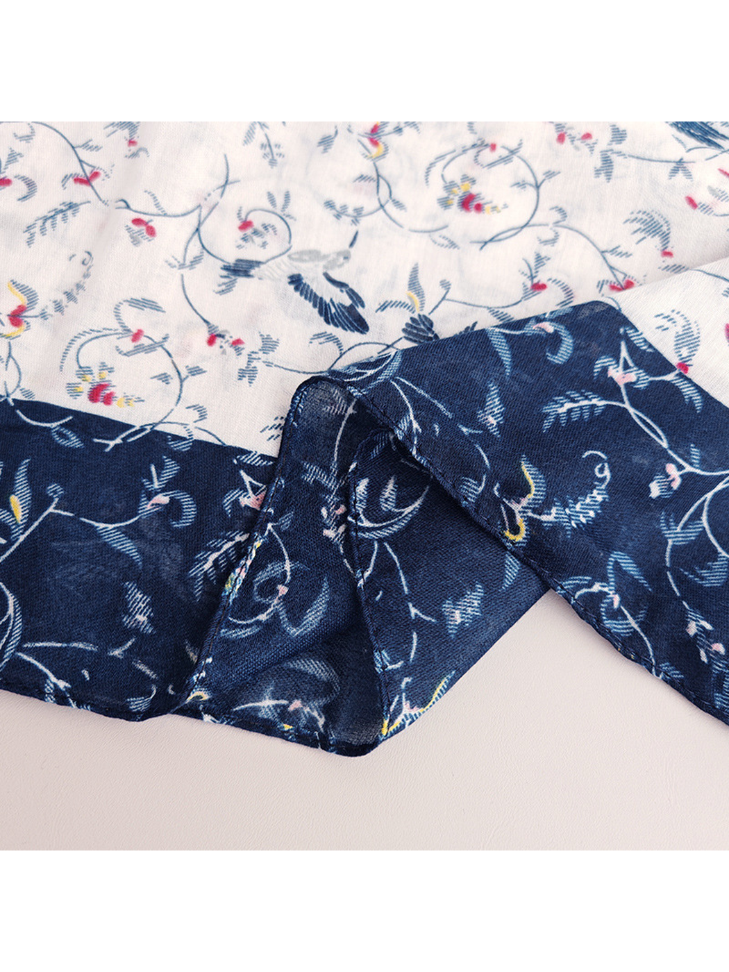 Close-up of the narrow hemmed navy border and lighter patterned field