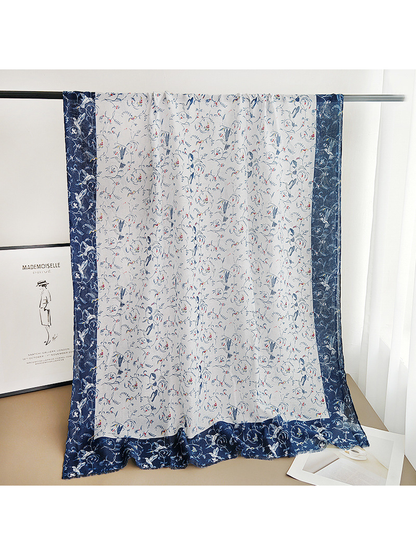 Full-length ivory patterned scarf with wide navy borders displayed over a rail