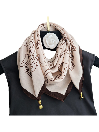 Cream and dark brown patterned square scarf with gold-tone corner charms