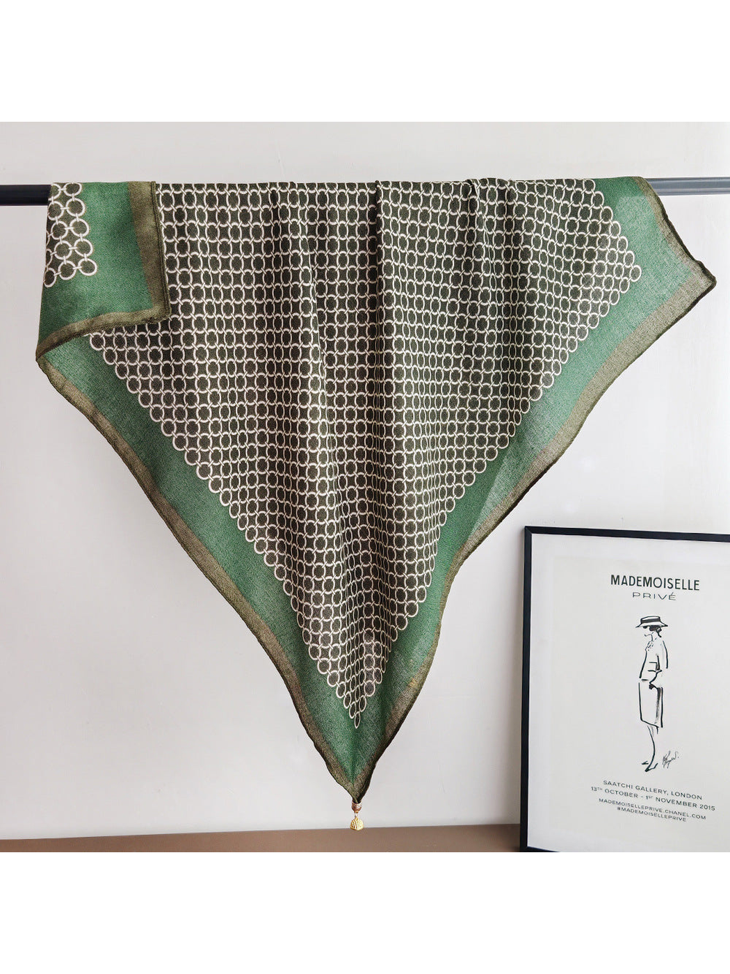 Green square scarf with an interlocking ring pattern, full draped view