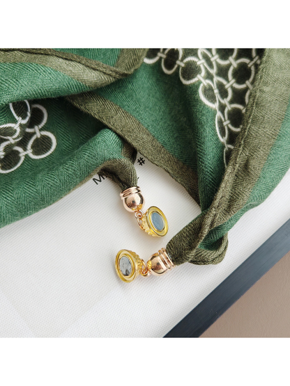Close-up of the scarf's gold-tone circular end ornaments