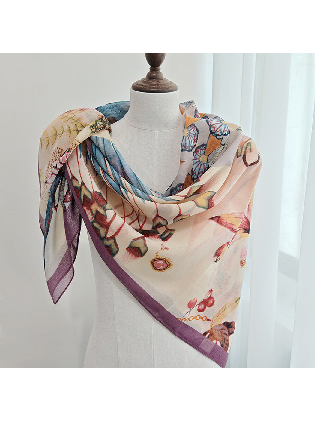 Multicolor floral scarf draped around a dress form