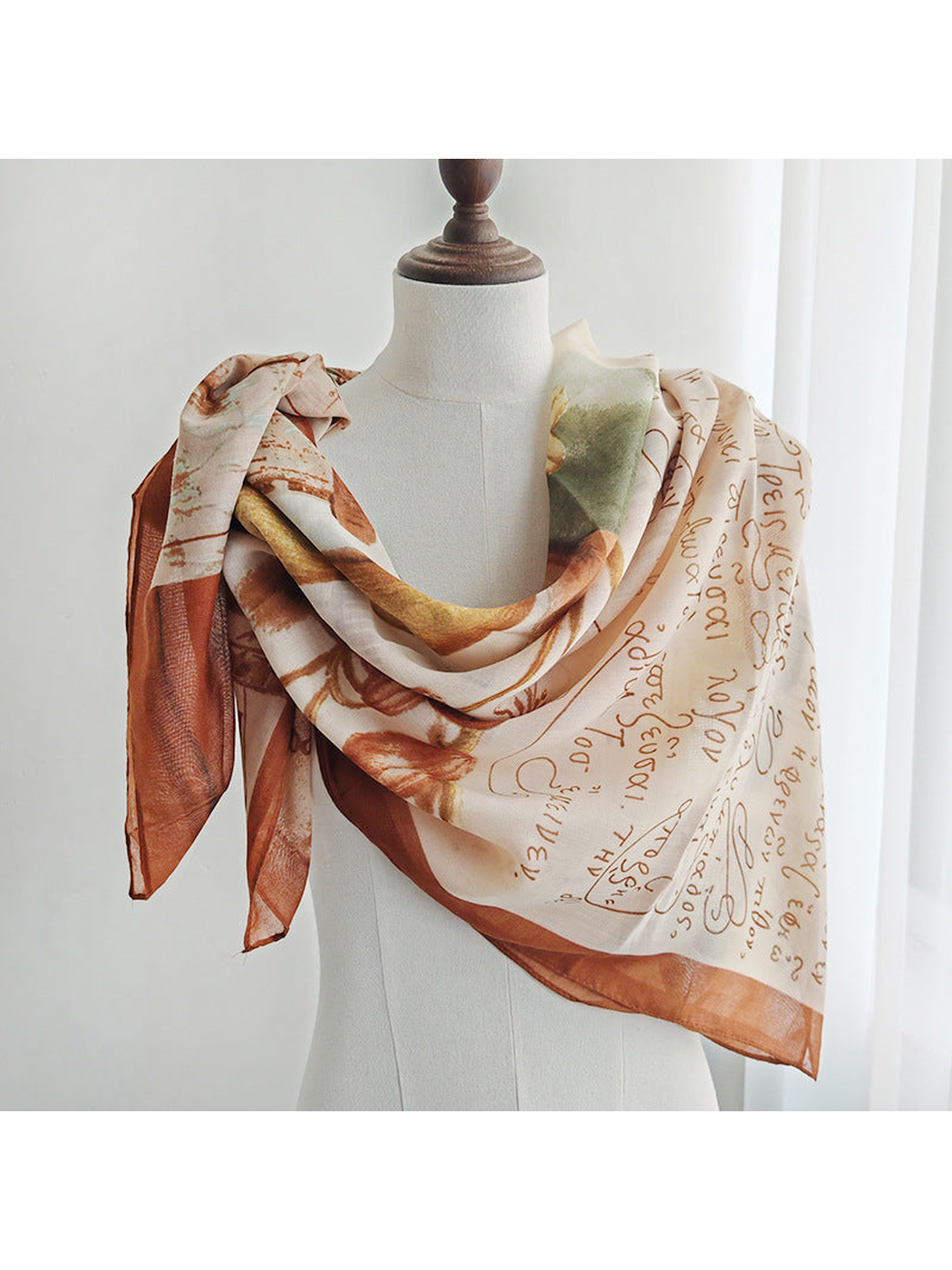 Multicolor printed scarf draped around a dress form