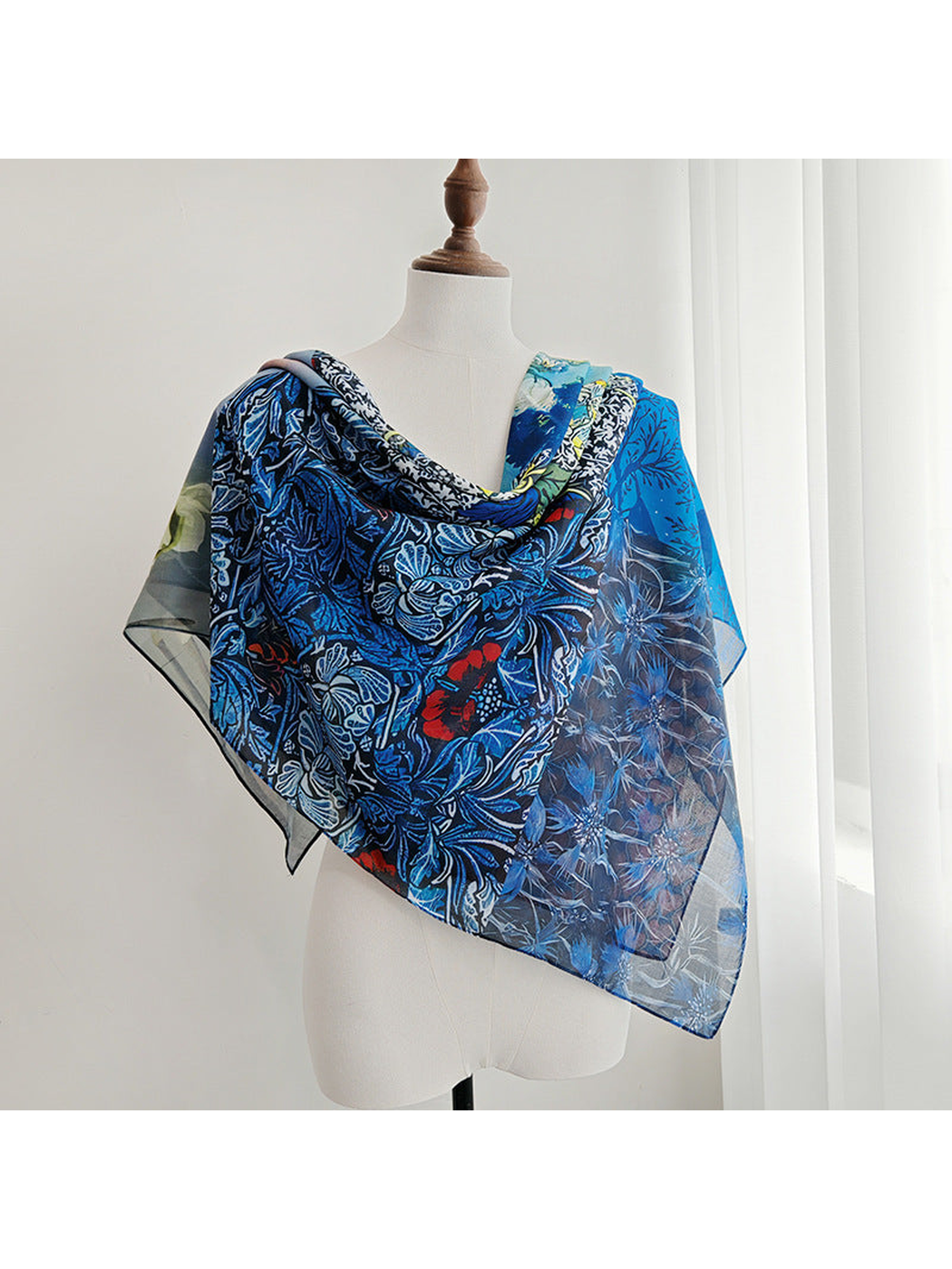 Blue floral patchwork scarf draped across a mannequin