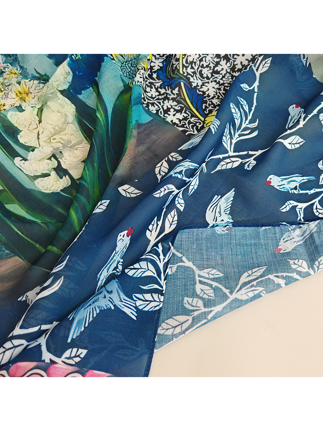 Close-up of the scarf's semi-sheer weave and bird-and-botanical print