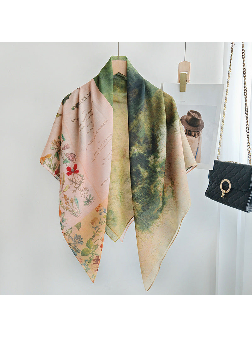 Square scarf with pink botanical panels and a green landscape print, draped view