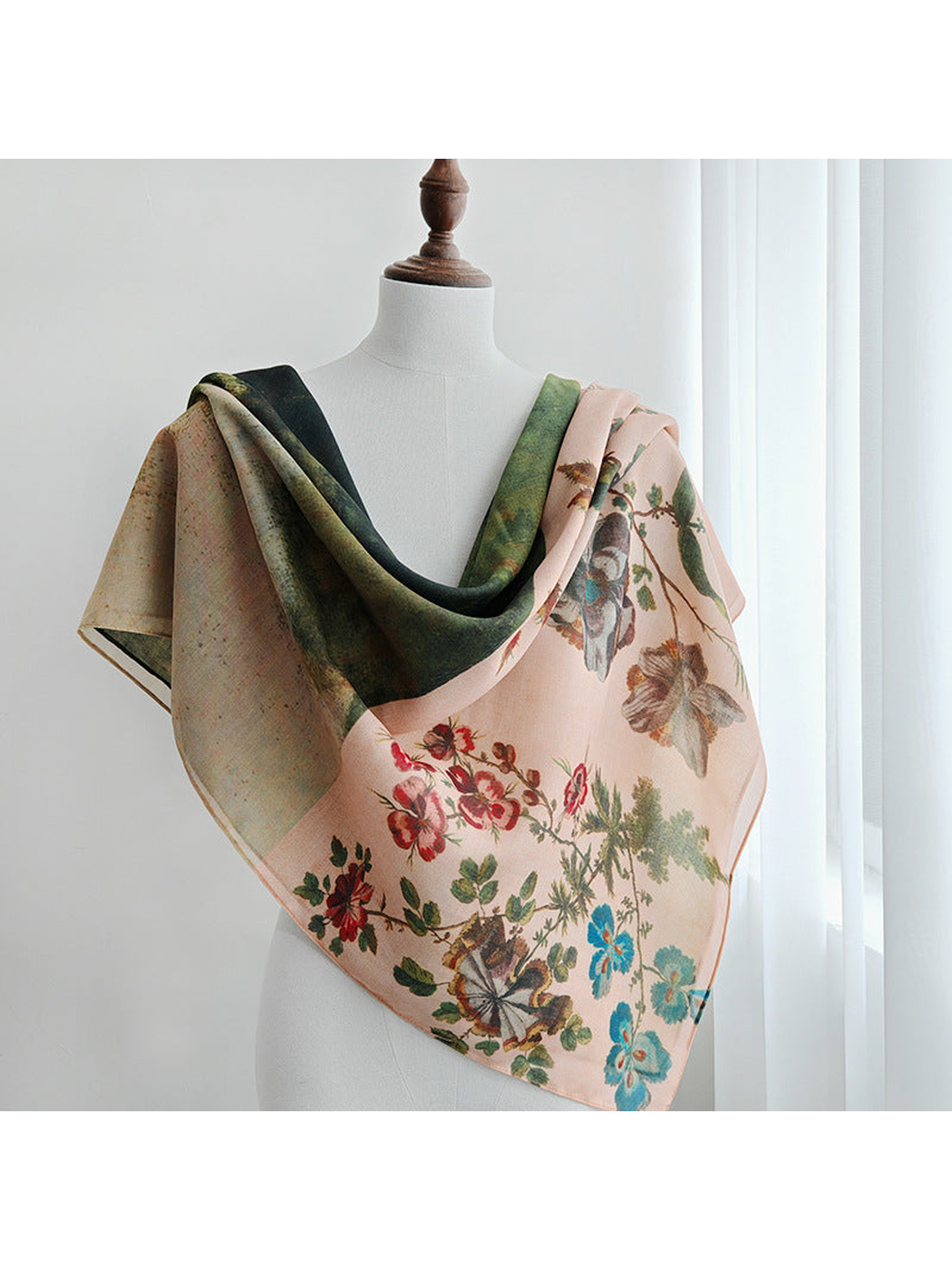 Botanical and landscape print scarf draped over a mannequin
