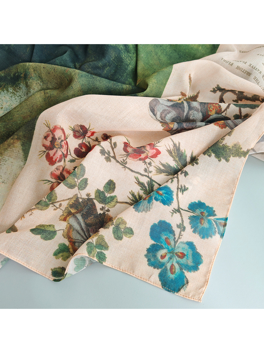 Close-up of the scarf's floral print, green landscape section and fine weave