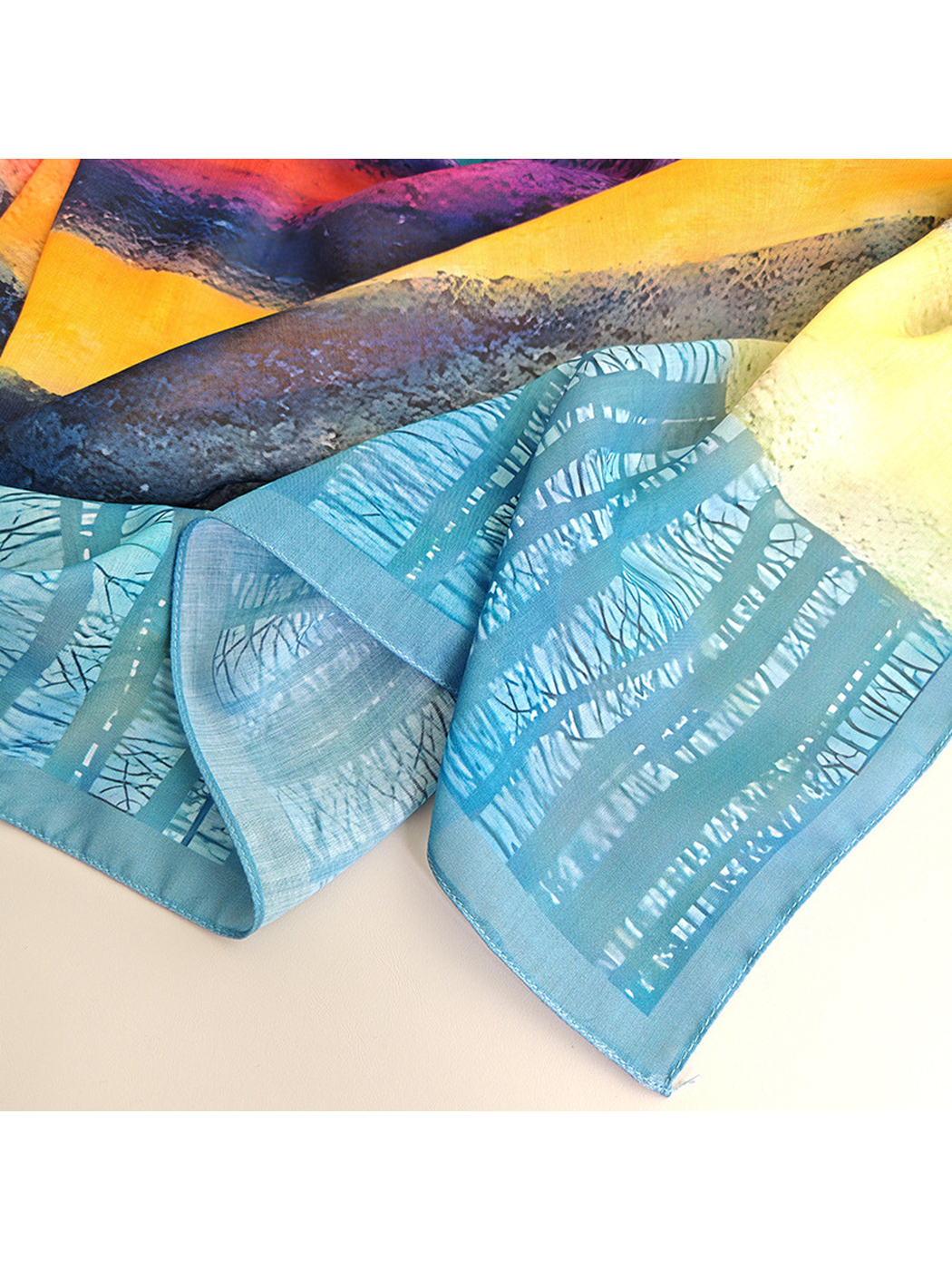 Close-up of the scarf's translucent blue border and multicolor print