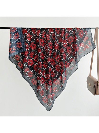 Square scarf draped over a rail to show its full floral pattern and border
