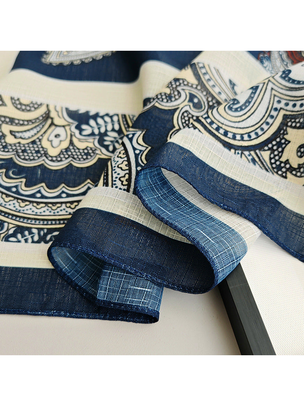 Close-up of the navy stitched edge and ornamental scarf border