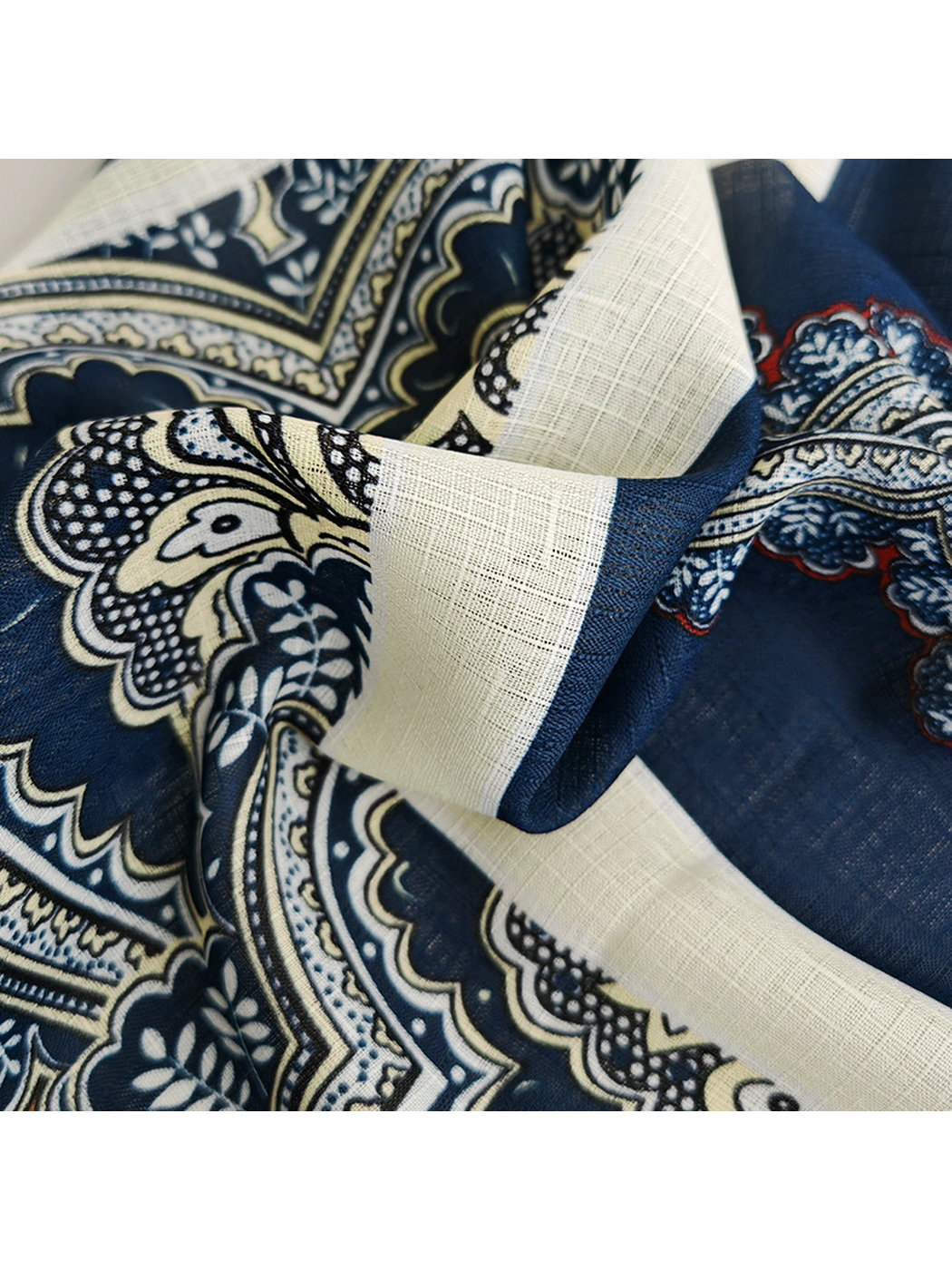 Close-up of the scarf's fine grid-like texture and contrasting navy border