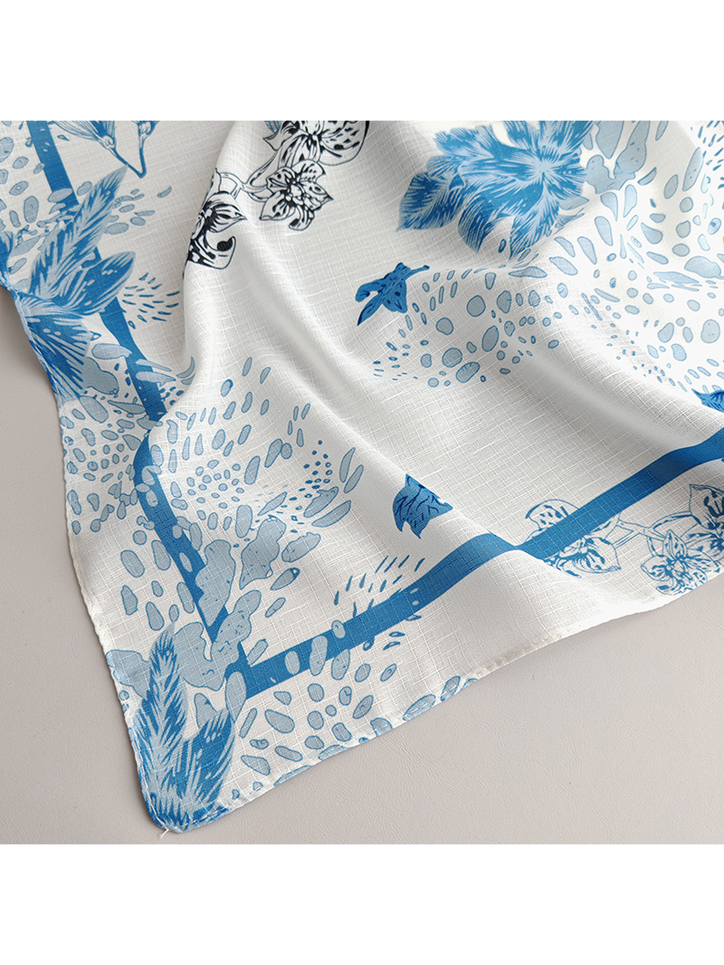 Close-up of the scarf's pale blue border and botanical print