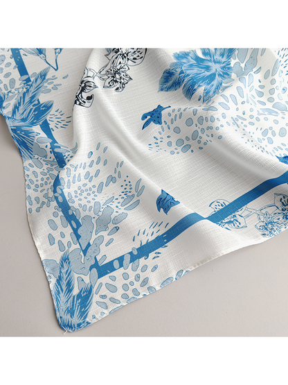 Close-up of the scarf's pale blue border and botanical print