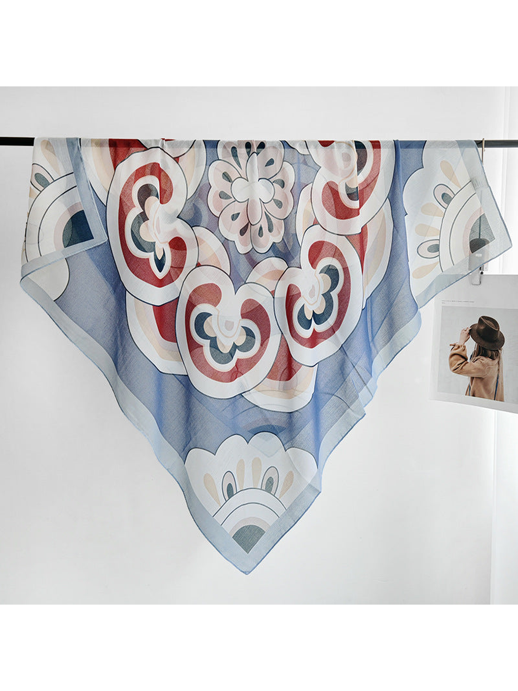 Light blue patterned square scarf displayed in a full draped view