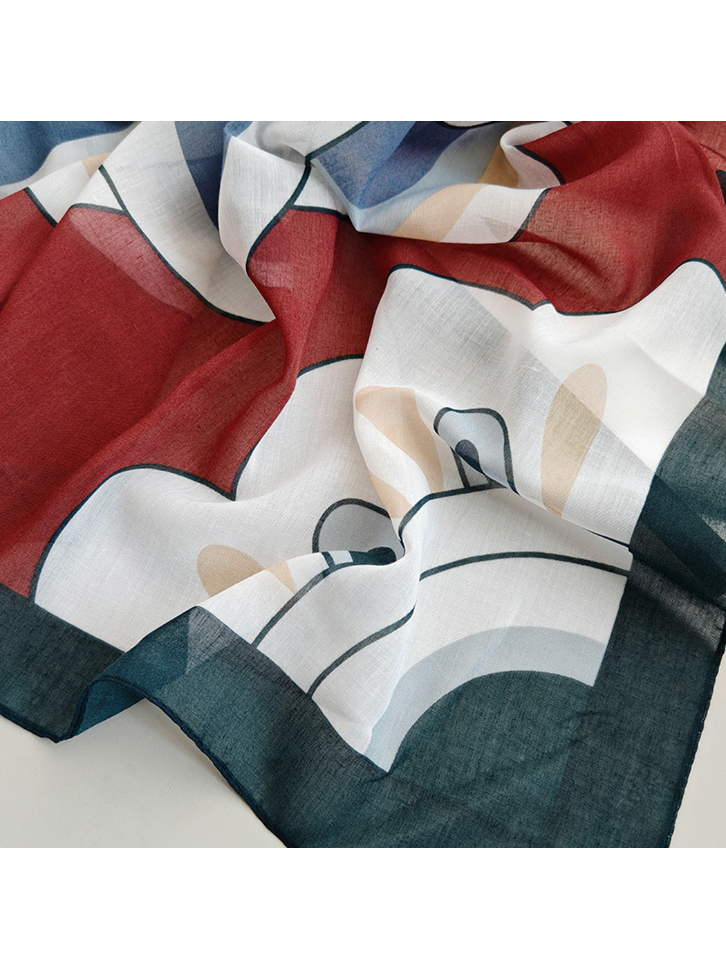 Close-up of the burgundy, white and dark green printed pattern and border