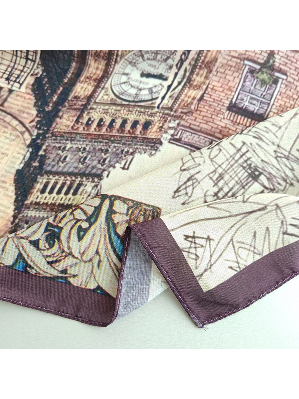 Close-up of the scarf's narrow dark purple stitched border