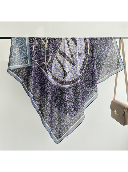 Purple and navy square scarf draped over a display rail