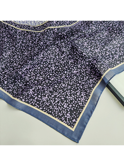 Close-up of the purple speckled print and blue border corner