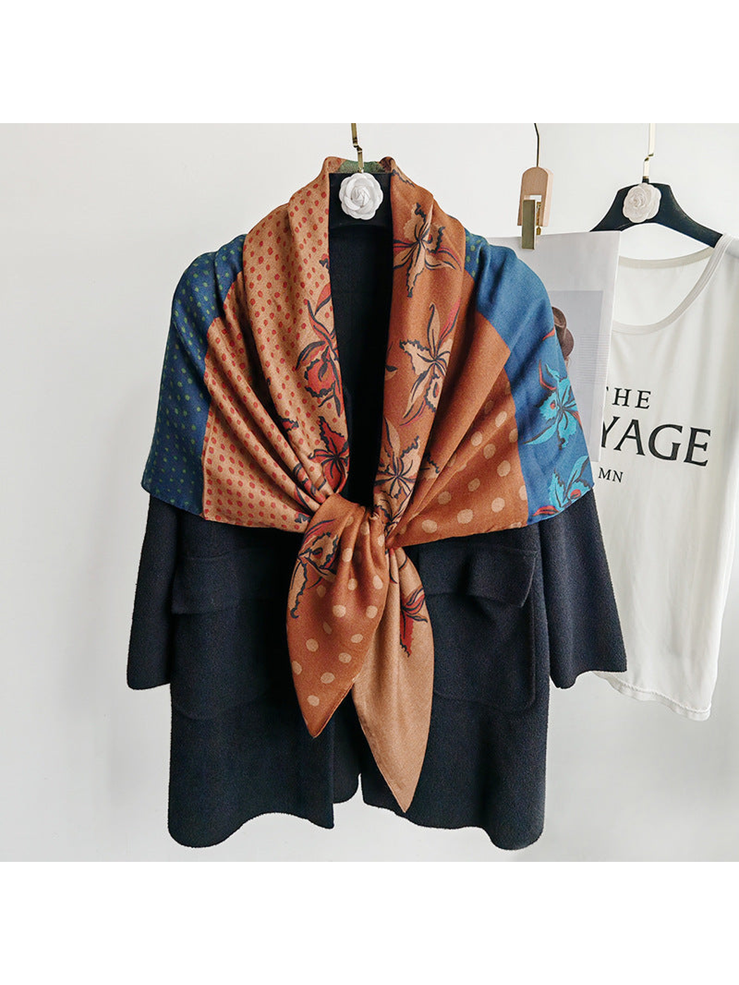 Multicolor square scarf tied at the front over a black coat