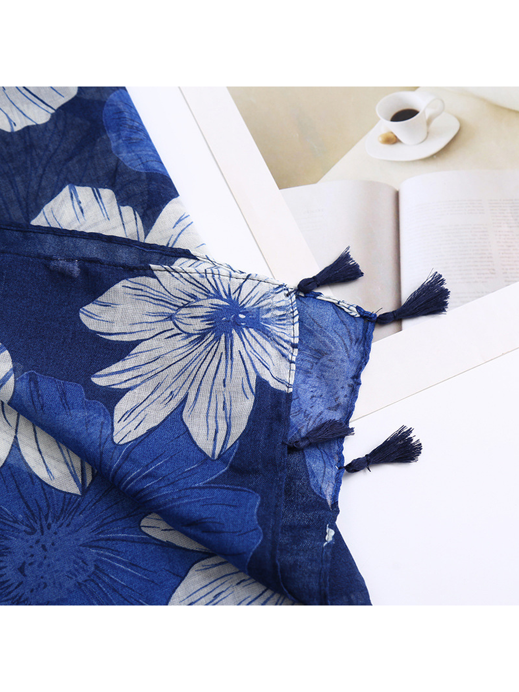 Close-up of the navy scarf edge with dark tassel trim