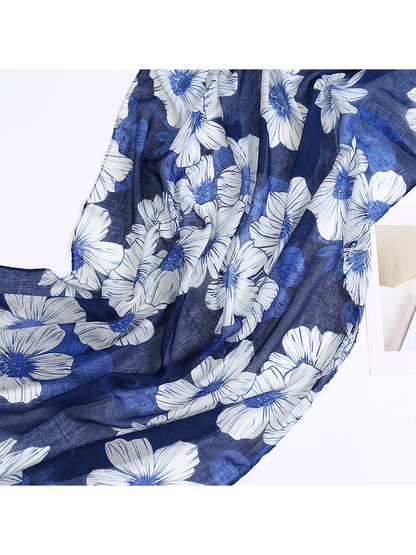 Close-up of large white and smaller blue flowers on the navy scarf