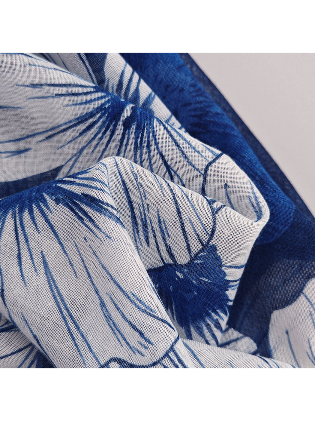 Close-up of the scarf's semi-sheer fine grid texture and floral print
