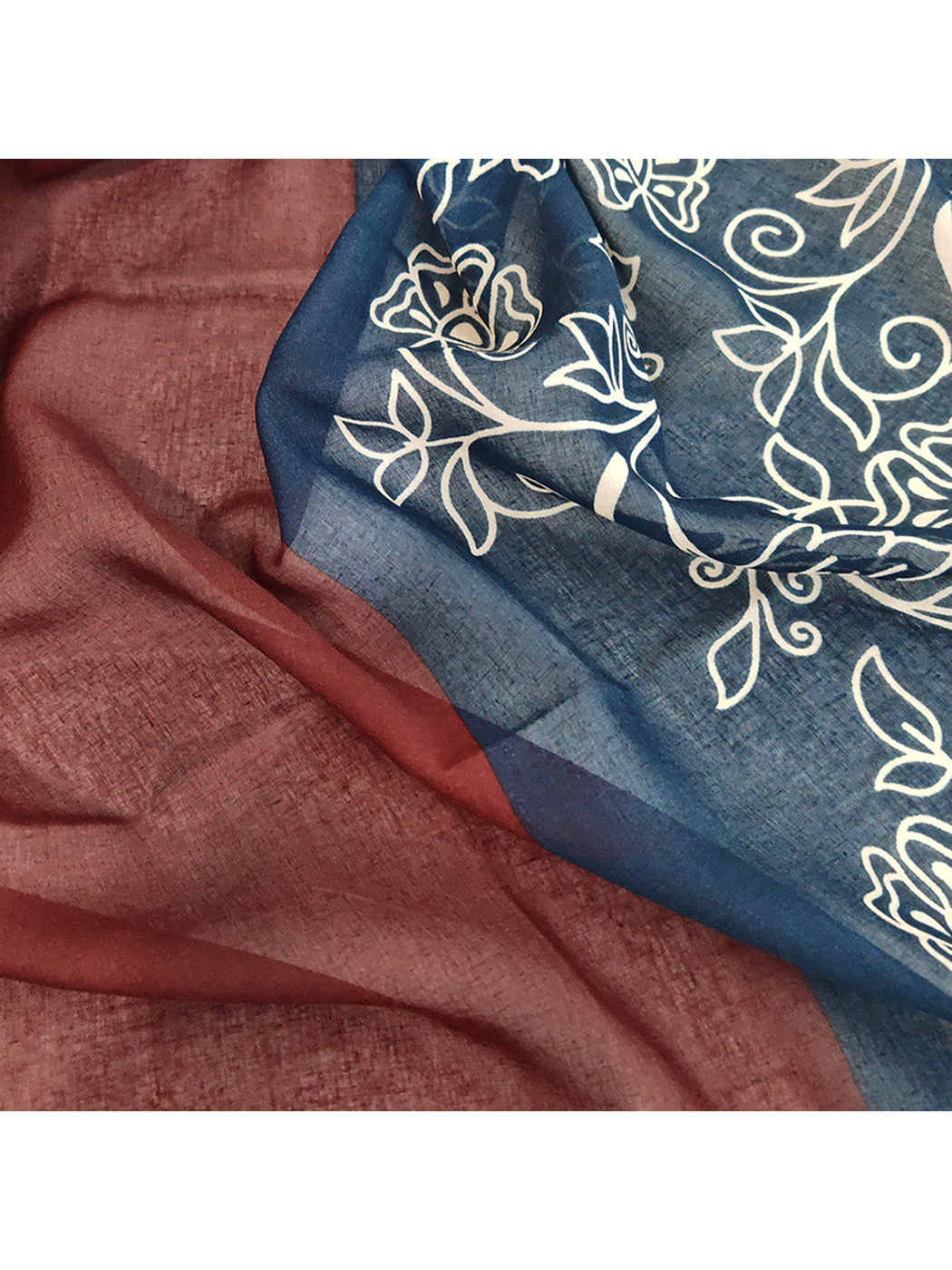 Close-up of the semi-sheer burgundy and navy scarf panels
