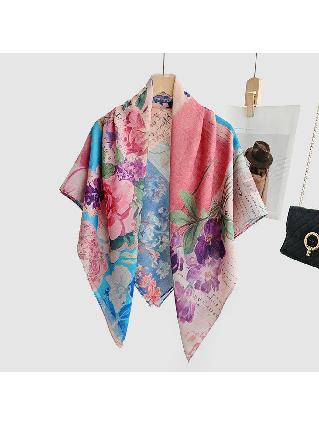 Multicolor floral square scarf draped loosely over a hanger