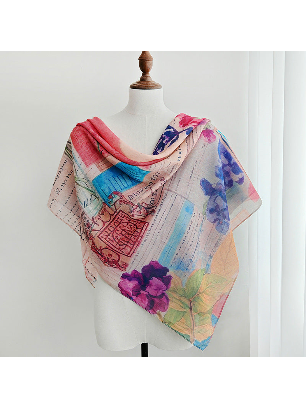 Multicolor floral square scarf draped across a dress form
