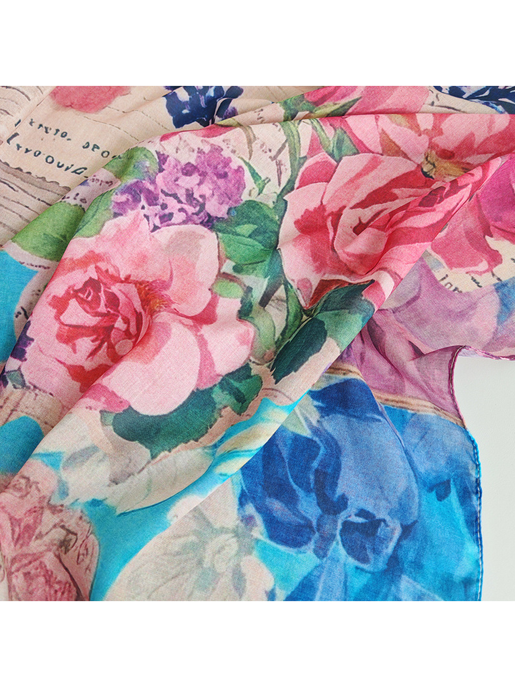 Close-up of the scarf's pink and blue floral print and fine weave