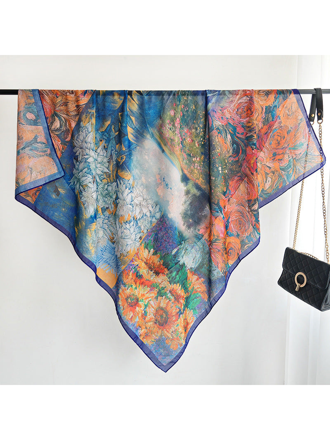 Multicolor floral square scarf draped across a display rail