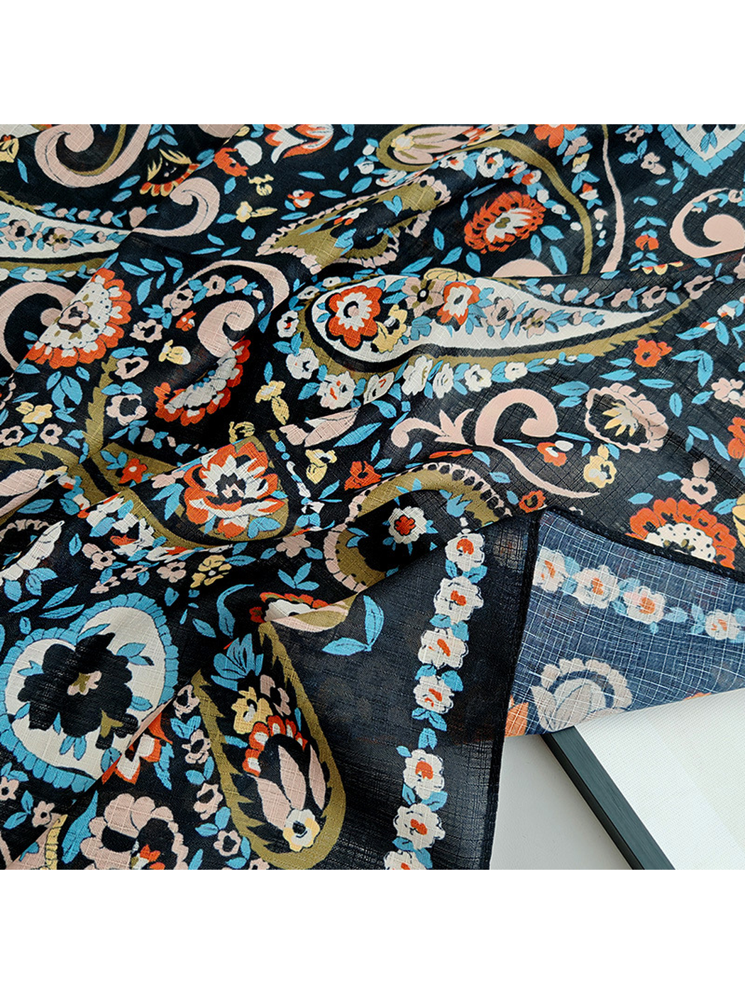 Close-up of the paisley print and fine semi-sheer crosshatched texture