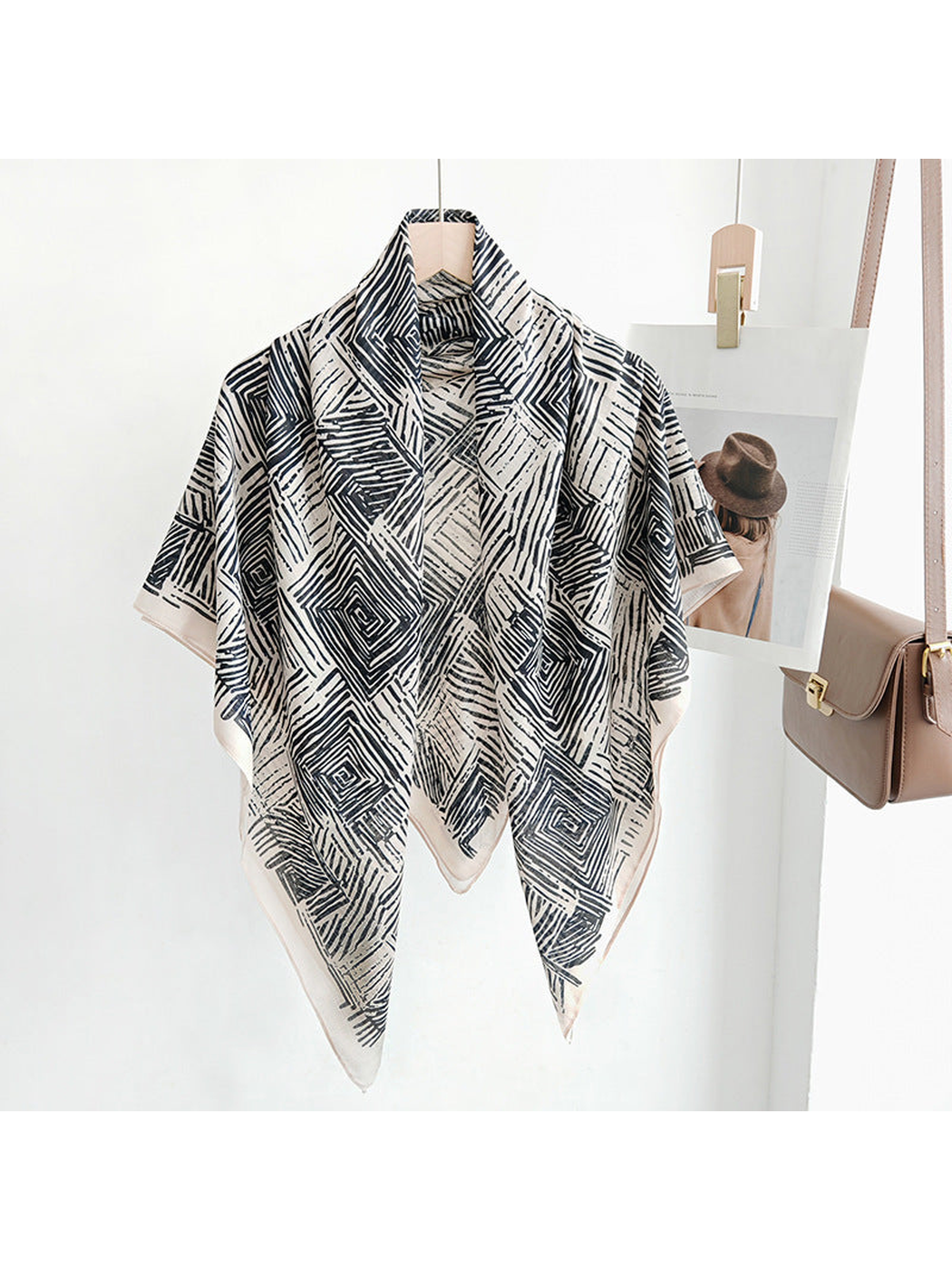 Black and beige geometric square scarf draped on a hanger