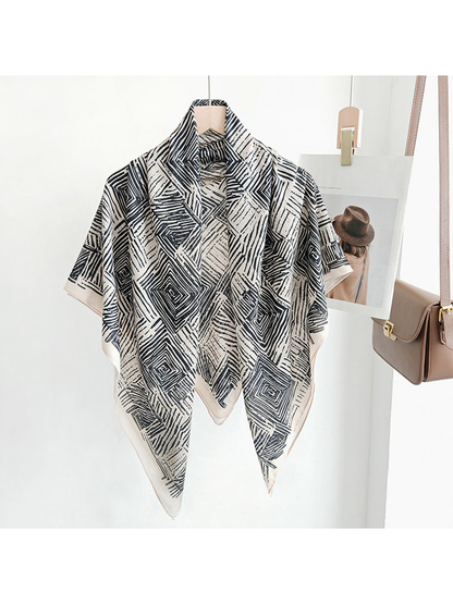 Black and beige geometric square scarf draped on a hanger